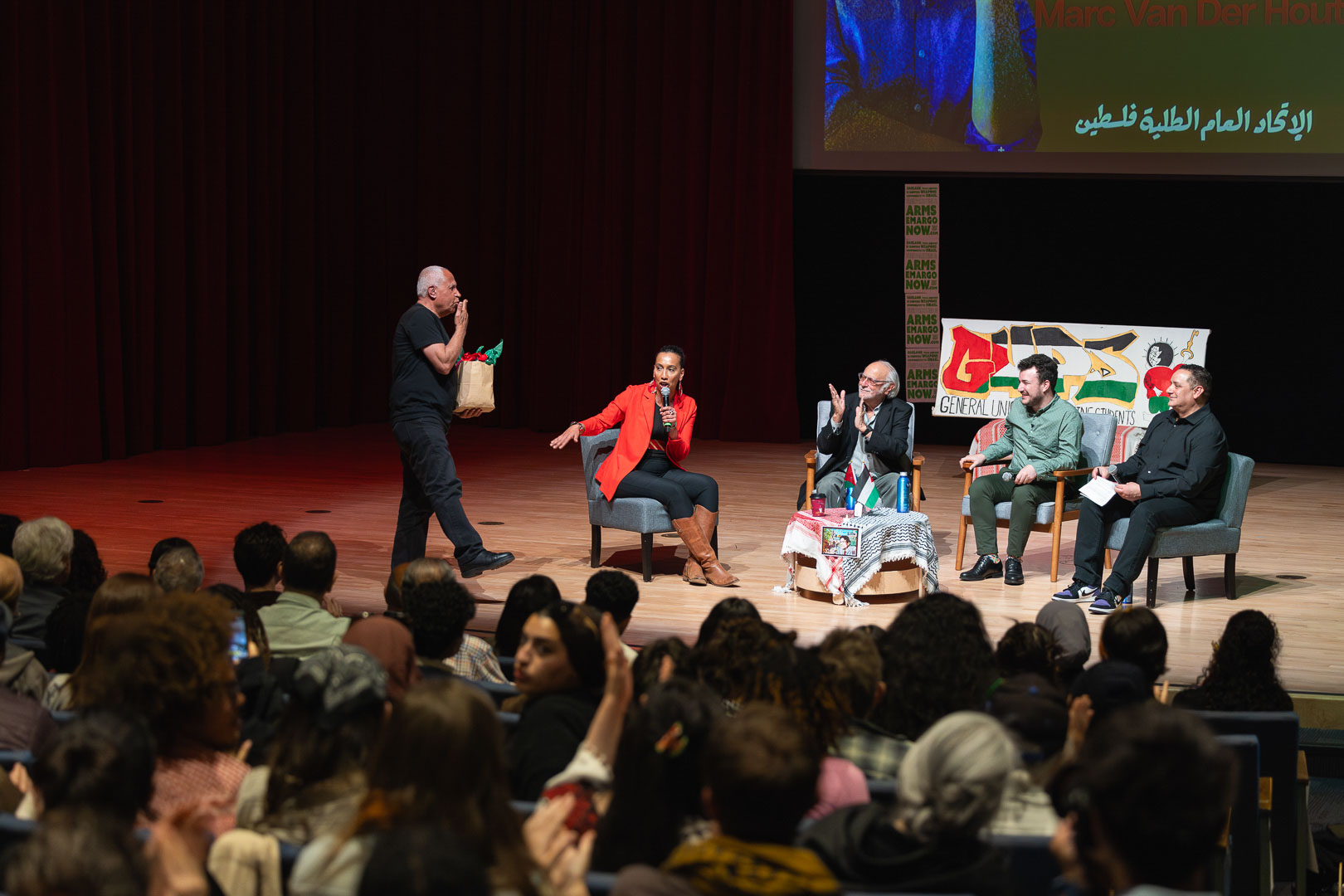 A wider shot of the stage and the full audience