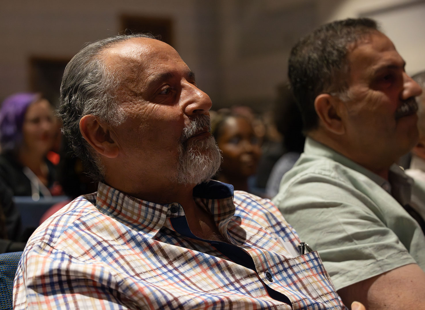 A closeup of an older man in the crowd