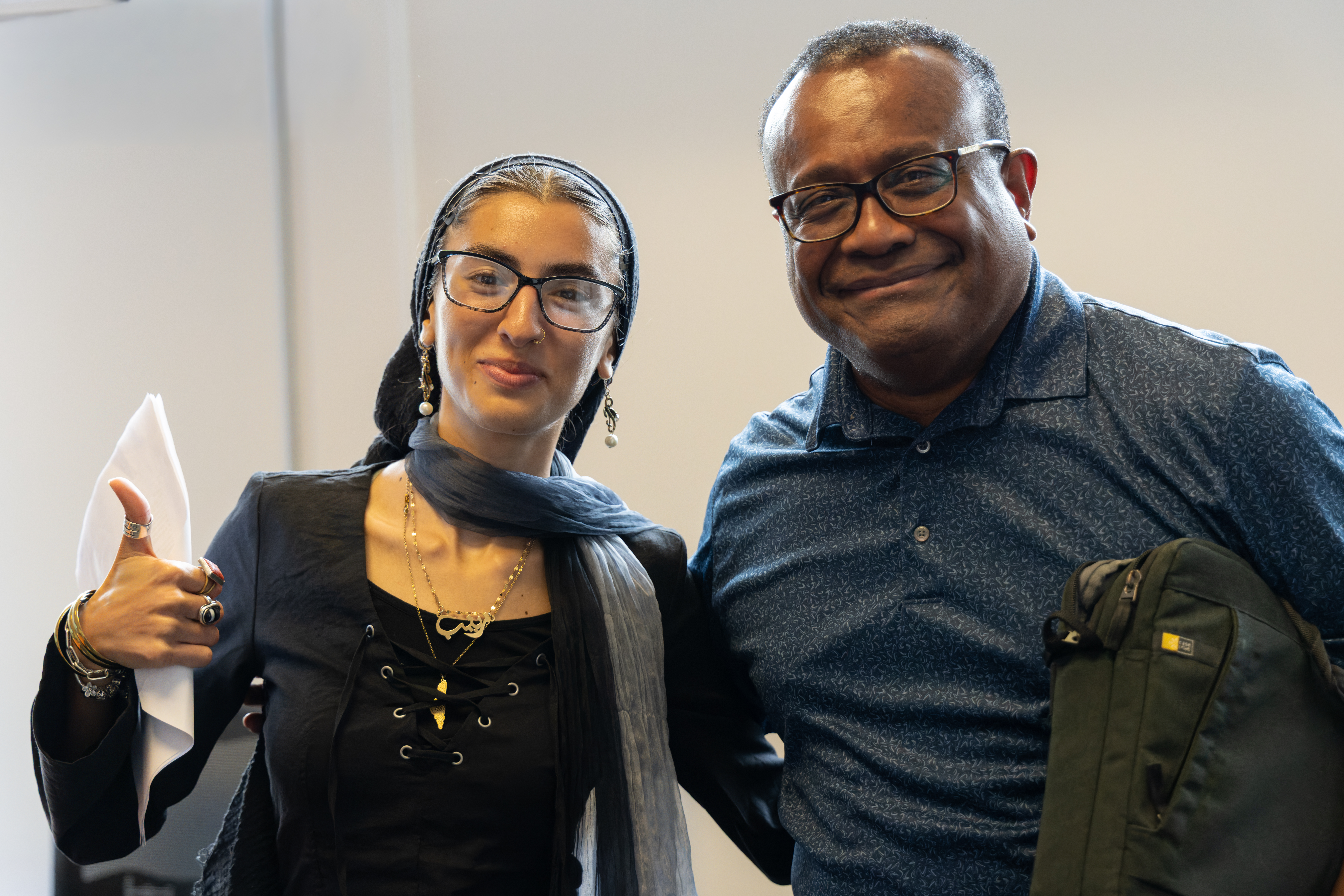 A student and a professor posing together.
