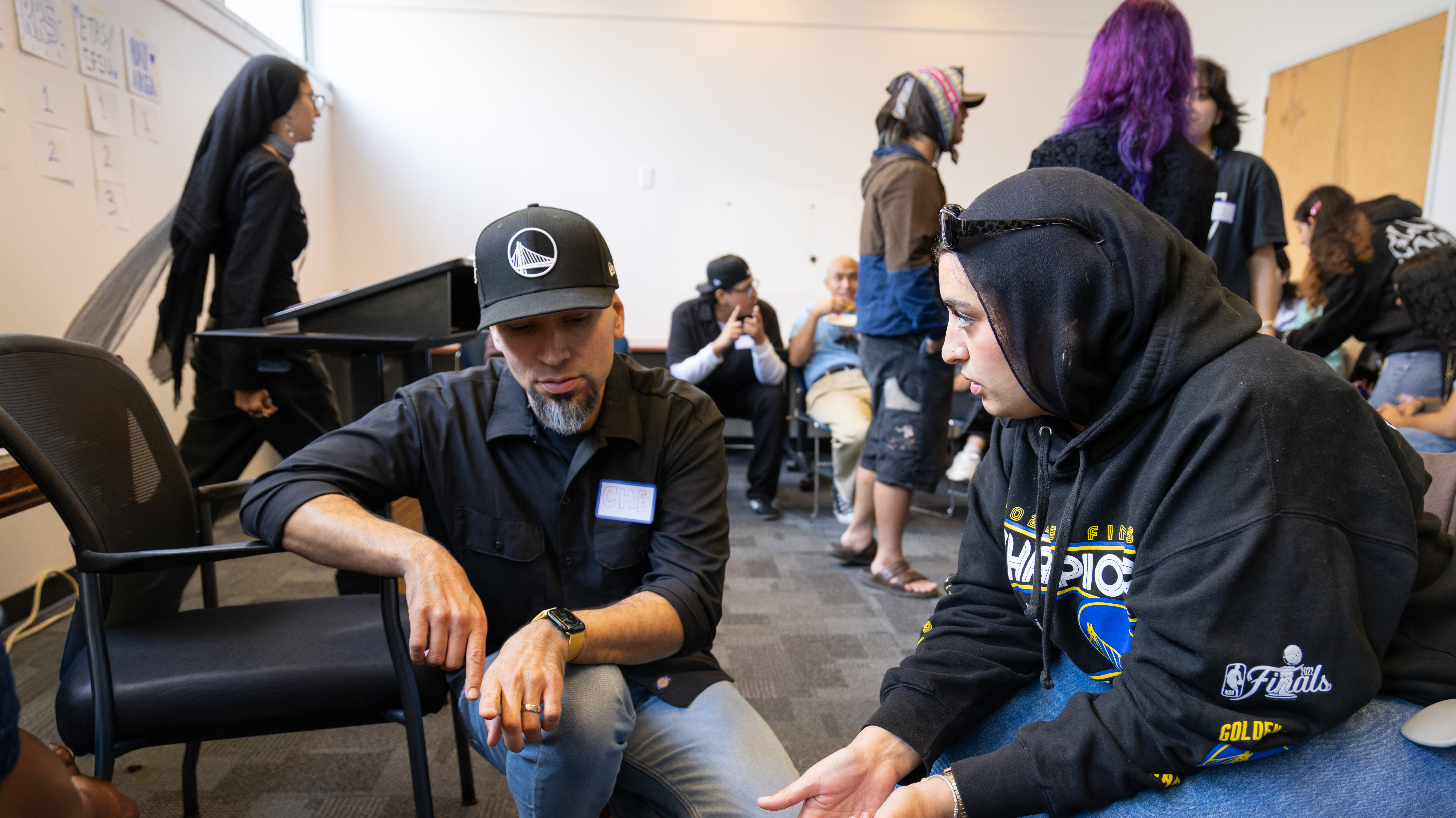 Two faculty discussing gameplan.