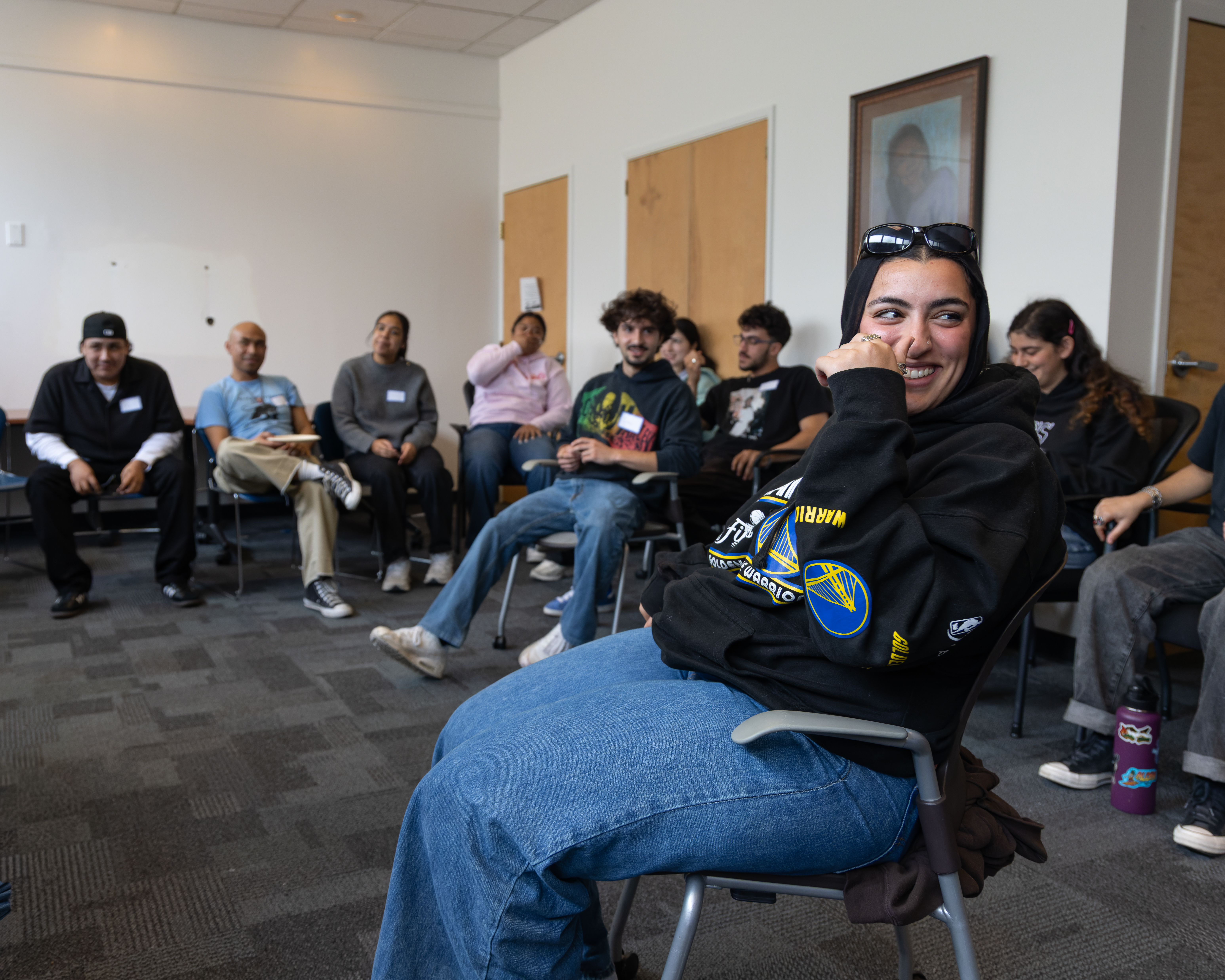 A faculty member smirking at something off camera.