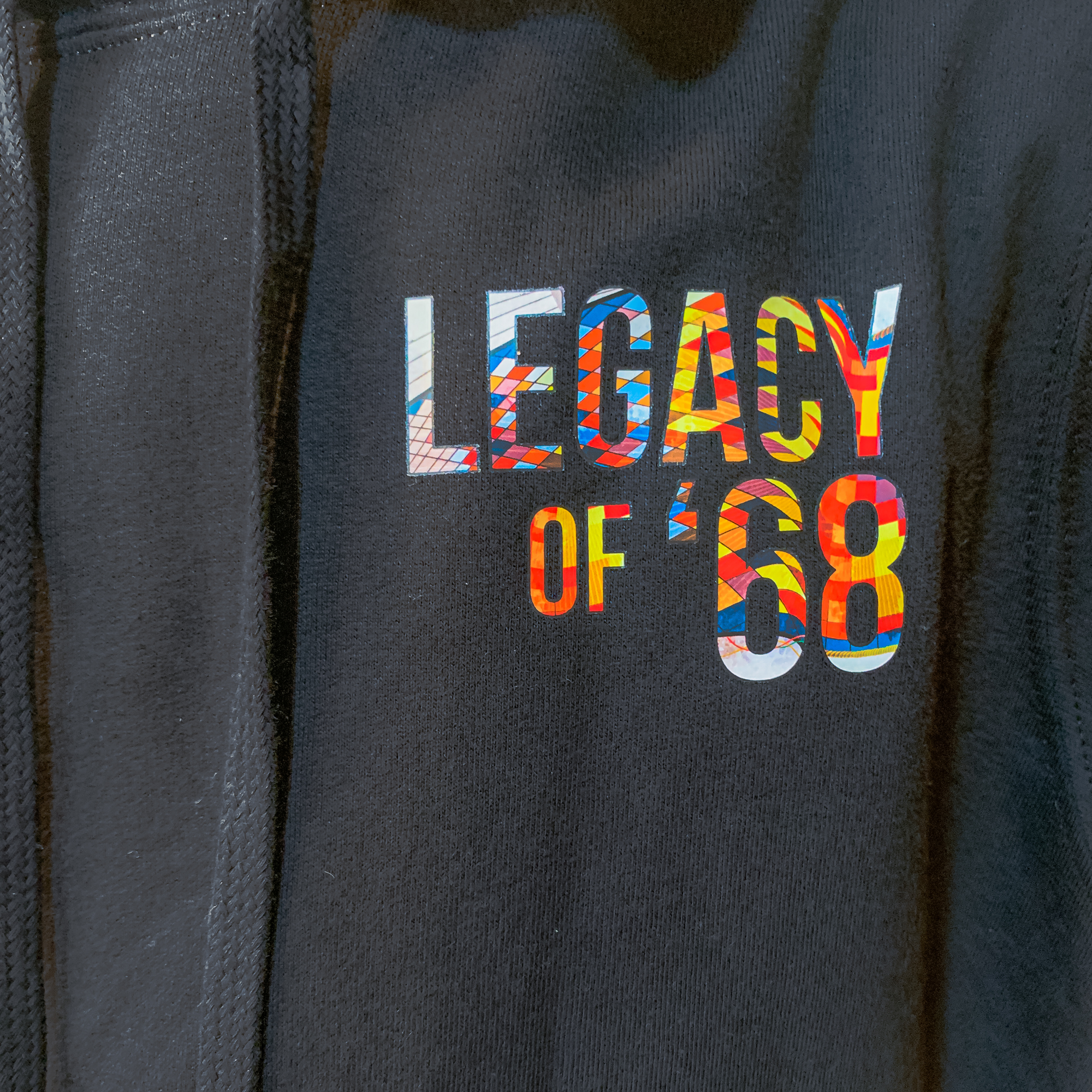 Detail shot of "Legacy of '68" on the front of the hoodie.