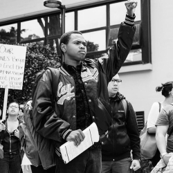 B&W photo of Hassani Bell protesting on SF State campus